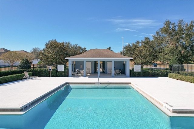 pool with fence and a patio