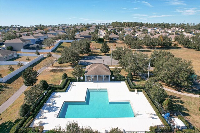 community pool featuring a residential view, a patio area, fence, and a gazebo