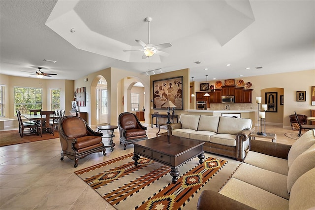 living room featuring light tile patterned floors and ceiling fan