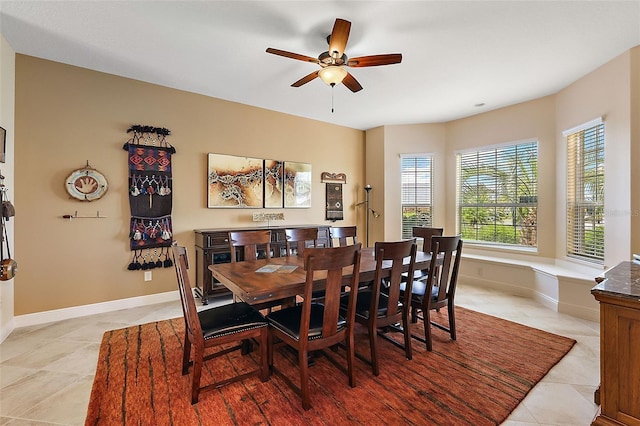 dining area with ceiling fan and light tile patterned floors