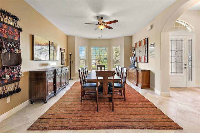 tiled dining room with ceiling fan