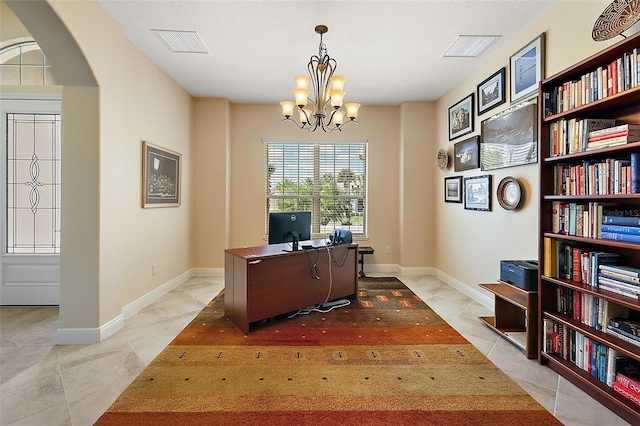 tiled home office featuring an inviting chandelier