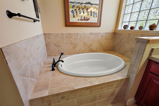 bathroom with tiled bath and vanity