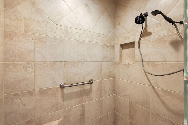 interior details featuring tiled shower