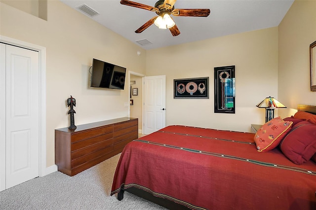 bedroom with ceiling fan, a closet, and light carpet