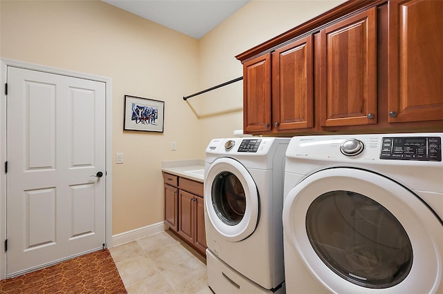 laundry room with cabinets and separate washer and dryer