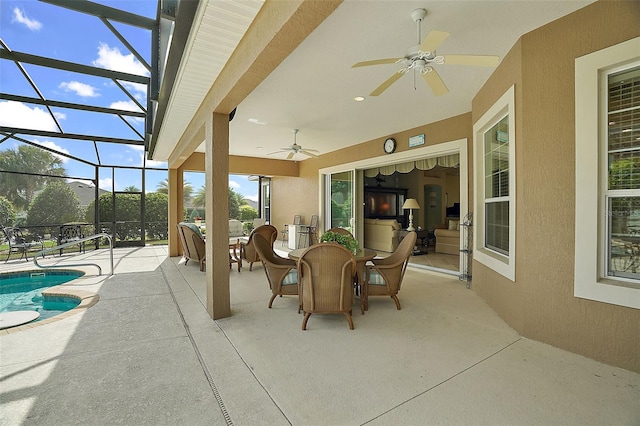 view of patio featuring ceiling fan and a lanai