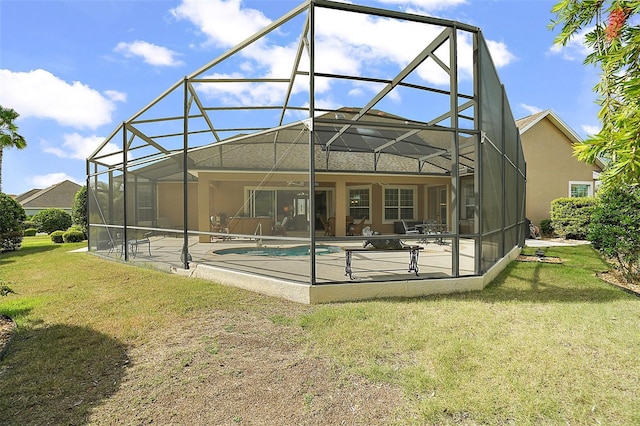 back of property with a patio area, a lanai, and a yard