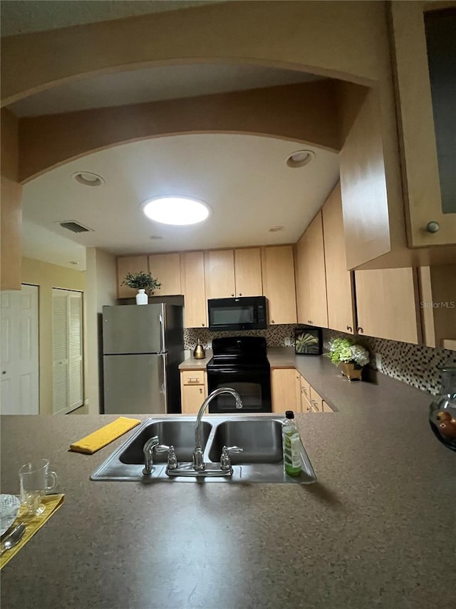 kitchen featuring tasteful backsplash, light brown cabinetry, black appliances, and sink