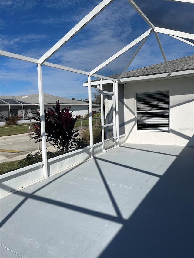 view of patio / terrace featuring a lanai