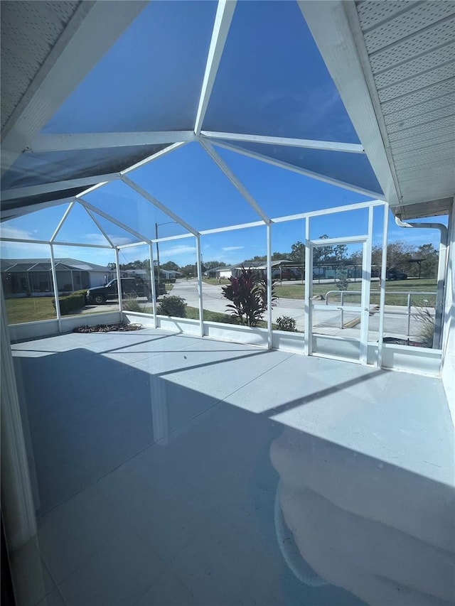 view of patio featuring a lanai