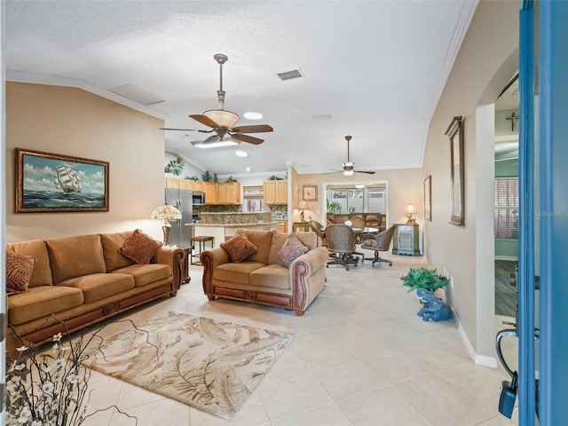 tiled living room featuring a textured ceiling, crown molding, and lofted ceiling