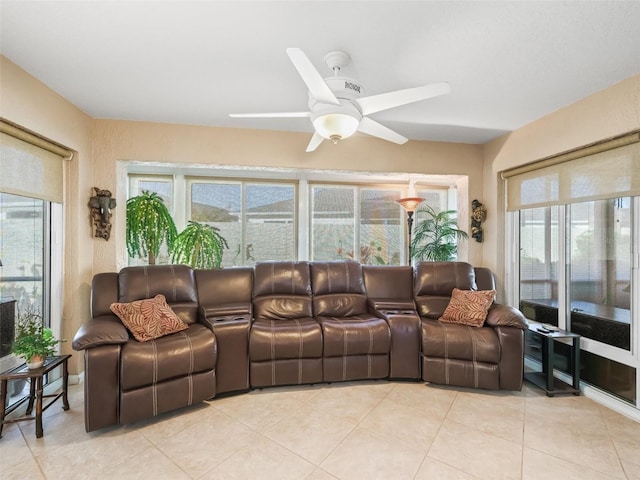 tiled living room featuring a wealth of natural light and ceiling fan