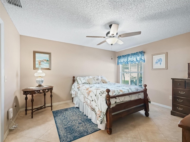 bedroom with light tile patterned floors, a textured ceiling, and ceiling fan