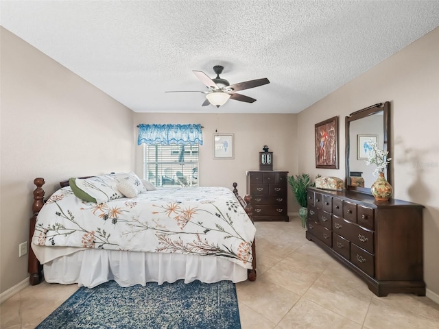 bedroom featuring a textured ceiling, ceiling fan, and light tile patterned flooring