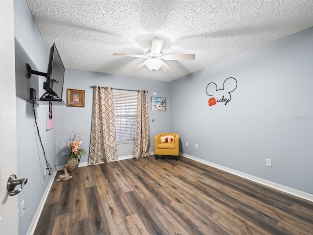 interior space featuring ceiling fan, hardwood / wood-style floors, and a textured ceiling