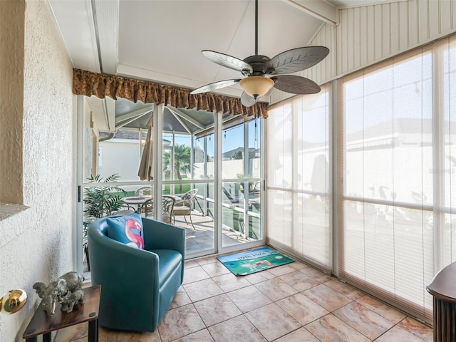 sunroom featuring ceiling fan and lofted ceiling