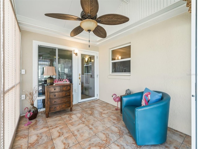 sunroom with ceiling fan