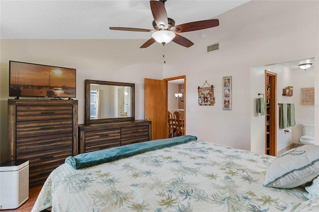 bedroom featuring wood-type flooring, vaulted ceiling, ensuite bath, and ceiling fan