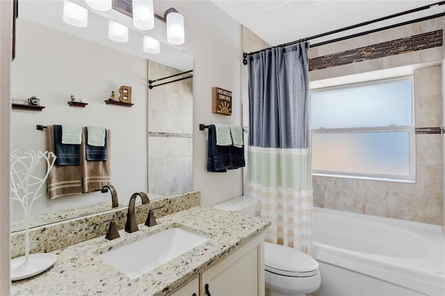 full bathroom with vanity, shower / bath combo, and toilet