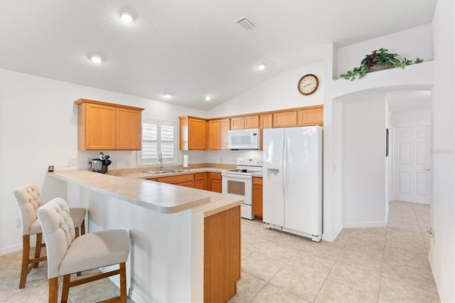 kitchen with sink, kitchen peninsula, lofted ceiling, white appliances, and light tile patterned floors