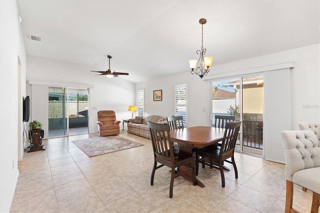 dining space featuring light tile patterned floors, ceiling fan with notable chandelier, a wealth of natural light, and lofted ceiling