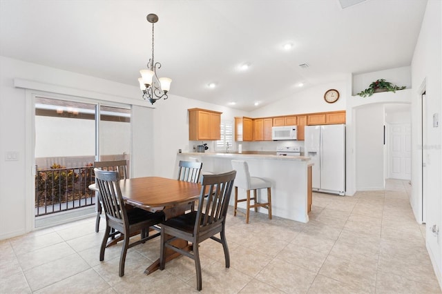 dining room featuring an inviting chandelier, vaulted ceiling, a healthy amount of sunlight, and light tile patterned flooring