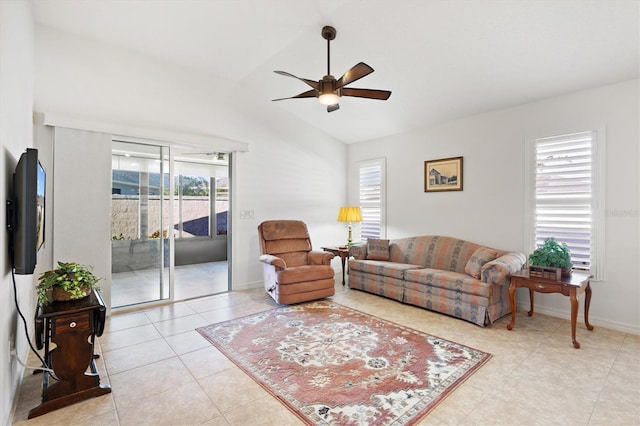 tiled living room with ceiling fan and vaulted ceiling