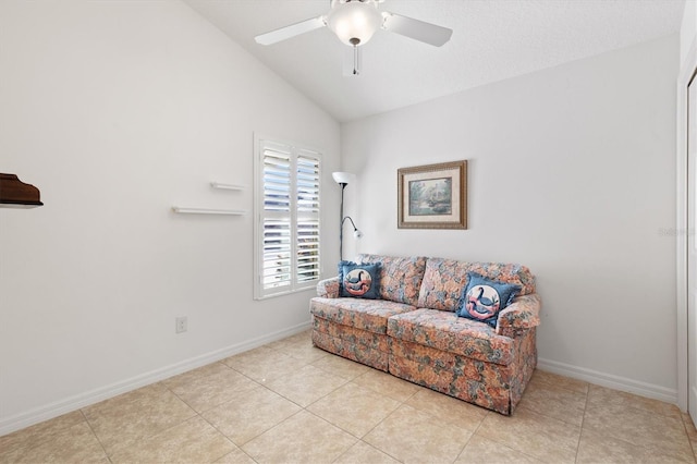 sitting room featuring ceiling fan, light tile patterned flooring, and vaulted ceiling