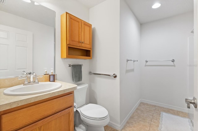 bathroom with tile patterned floors, vanity, and toilet