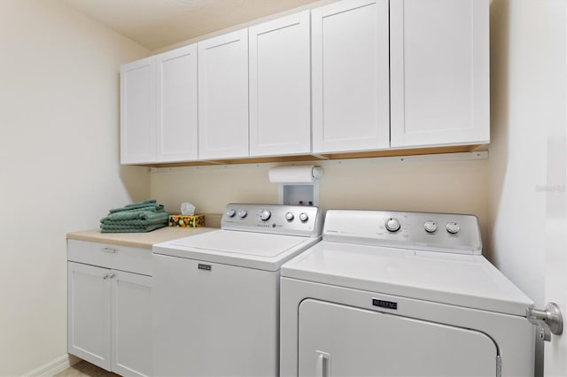 washroom featuring cabinets and washing machine and dryer