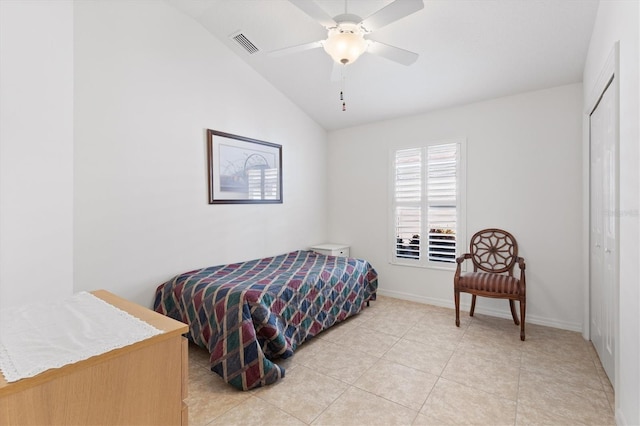 tiled bedroom with ceiling fan, lofted ceiling, and a closet