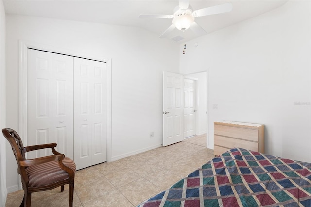 bedroom featuring light tile patterned floors, a closet, ceiling fan, and lofted ceiling