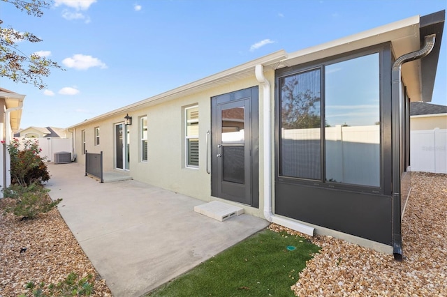 back of property with a patio and central AC unit