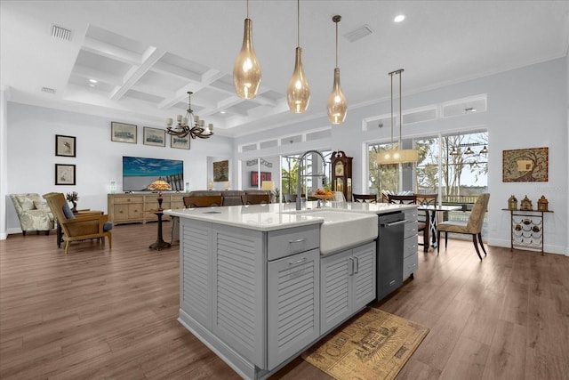 kitchen with a kitchen island with sink, plenty of natural light, pendant lighting, and coffered ceiling