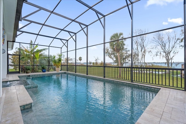 view of swimming pool with a yard, a patio, and a lanai