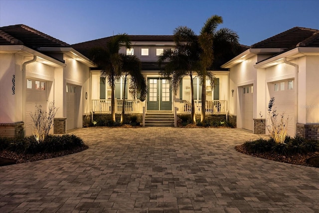 exterior space with covered porch and a garage