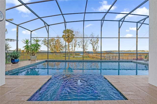 view of pool with a jacuzzi, a patio, and glass enclosure