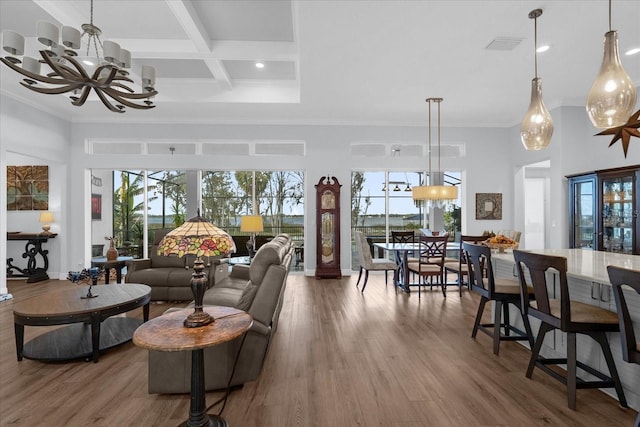 living room with a towering ceiling, coffered ceiling, a notable chandelier, beamed ceiling, and hardwood / wood-style floors