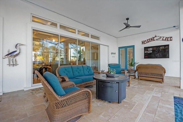 interior space with french doors and an outdoor living space with a fire pit