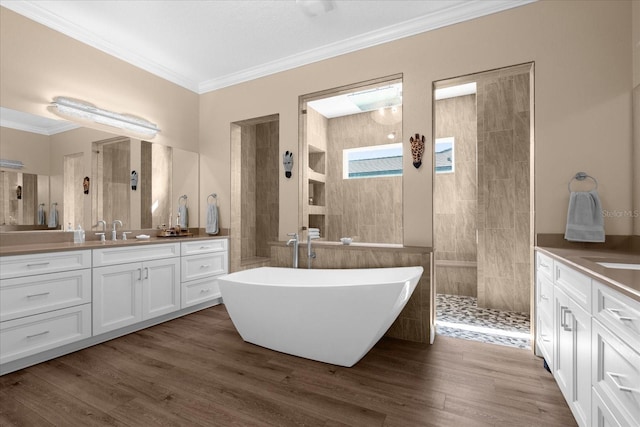 bathroom with plus walk in shower, vanity, hardwood / wood-style flooring, and crown molding