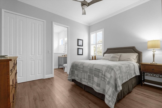 bedroom featuring a closet, ceiling fan, crown molding, and hardwood / wood-style floors