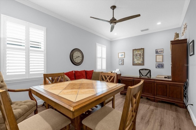 dining area with ceiling fan, wood-type flooring, and ornamental molding