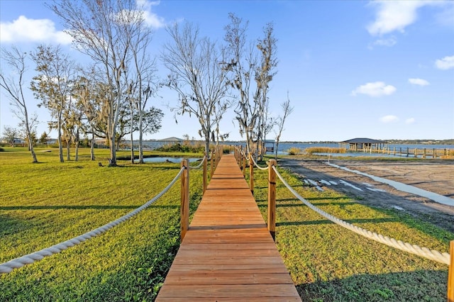 view of property's community featuring a yard and a water view