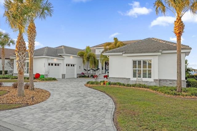 ranch-style house with a front yard and a garage