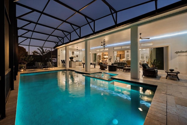 view of pool with ceiling fan, a patio area, an outdoor hangout area, and glass enclosure