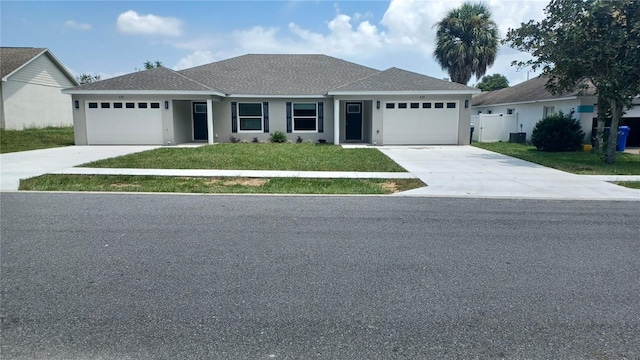 ranch-style home featuring a garage and a front lawn