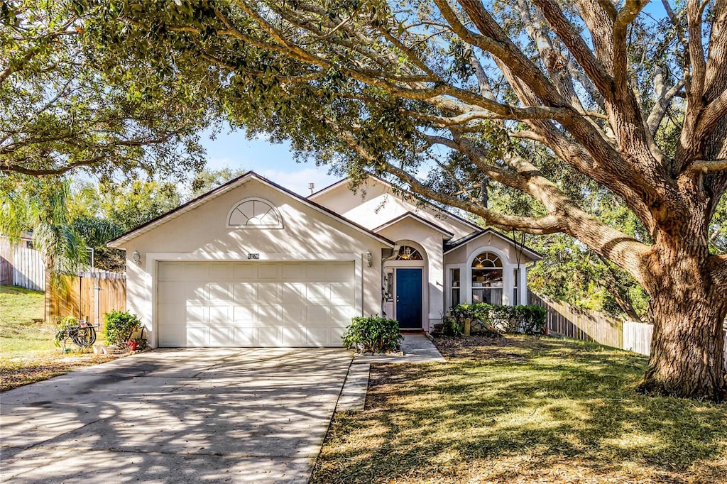 view of front of home featuring a front yard and a garage