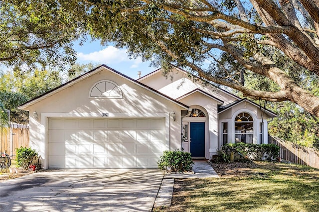 ranch-style home with a garage and a front yard