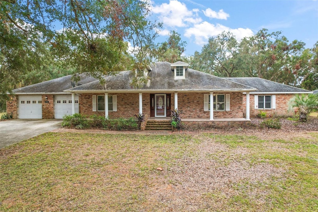 view of front of property with a front yard and a garage